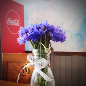 Close-up of purple flower vase on table