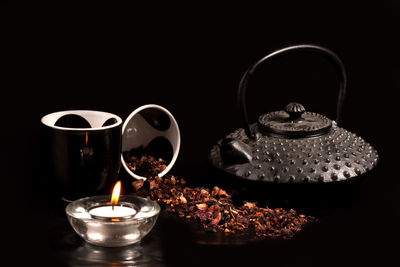 Close-up of wineglass on table against black background