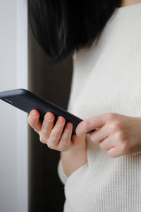 Woman holds a smartphone in her hands. touch screen smartphone, in hand. businesswoman 