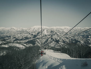 Ski lift over snowcapped mountains