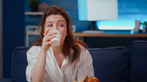 Young woman drinking coffee cup