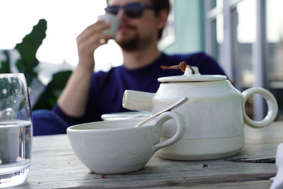 Midsection of coffee cup on table