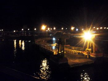 Illuminated bridge against sky at night