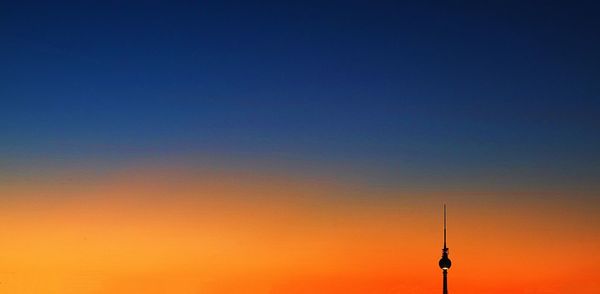 Low angle view of communications tower against sky