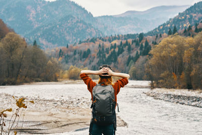 Rear view of man standing against mountain