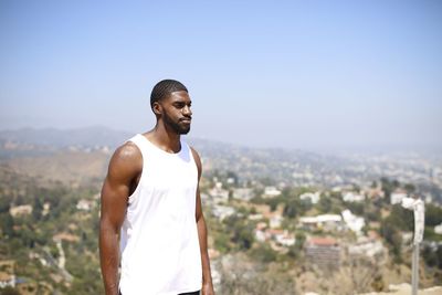 Man looking at city against sky