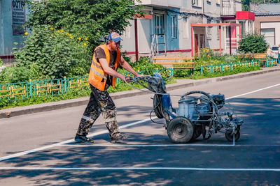 Man with bicycle on road