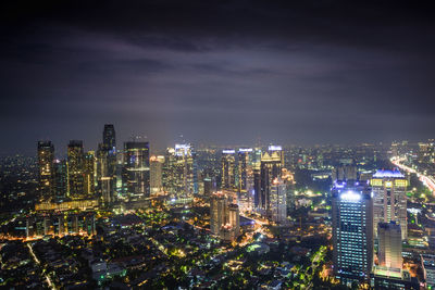High angle view of city lit up at night