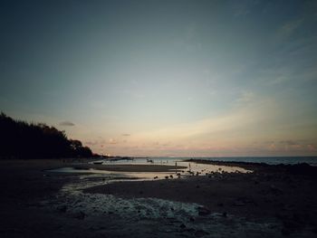 Scenic view of beach against sky during sunset