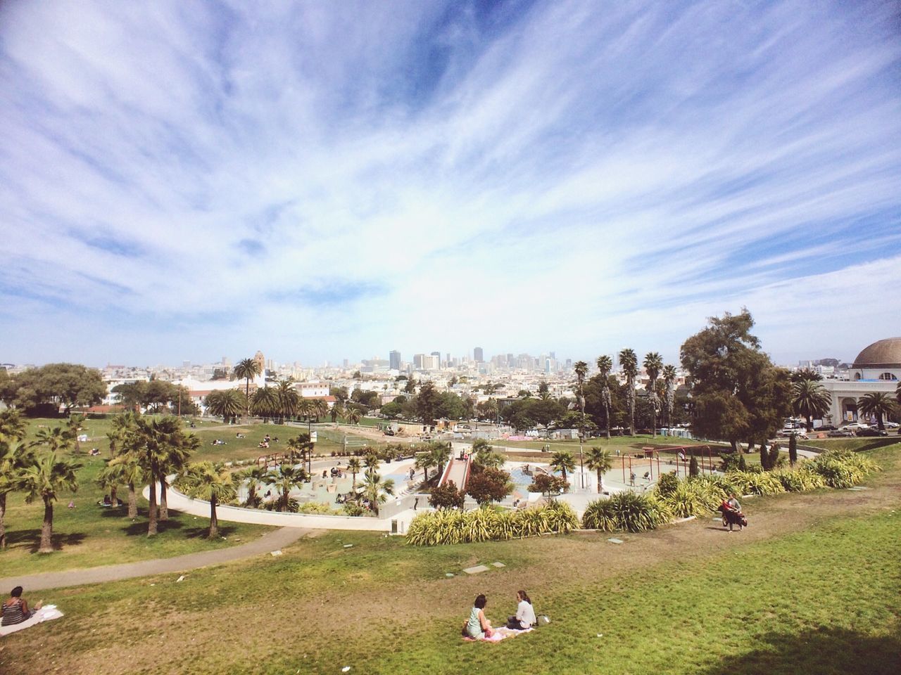 PEOPLE IN PARK AGAINST SKY