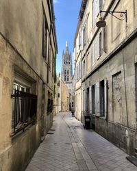 Narrow alley amidst buildings in city