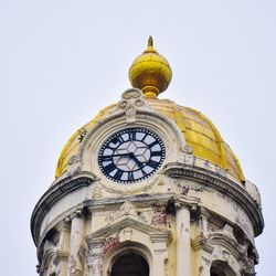 Low angle view of clock tower against clear sky