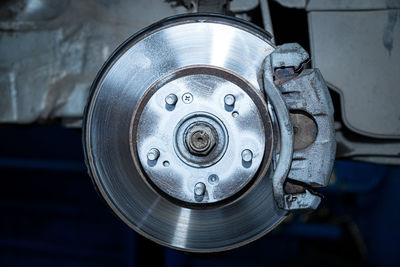 Close-up of a car hub, brake caliper, brake pads, brake disc, wheel bearing prepared for repair. 