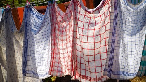 Stack of clothes hanging on clothesline