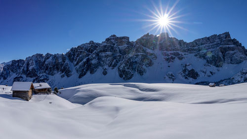 Scenic view of snowcapped mountains against clear blue sky