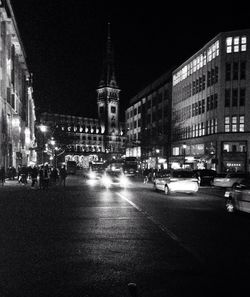 Illuminated city street at night