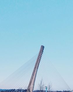 Low angle view of crane against clear blue sky