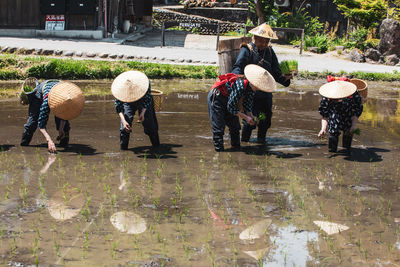 Group of people walking on street during rainy season