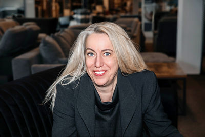 Radiant mature lady with silver hair, exuding charisma in a formal black ensemble