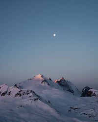 Scenic view of snowcapped mountain against clear sky during winter