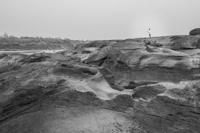 Rock formation on land against clear sky