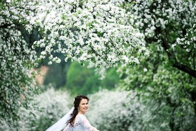 Young woman standing on tree