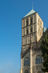 Low angle view of church - st. paulus cathedral, muenster -  against clear blue sky