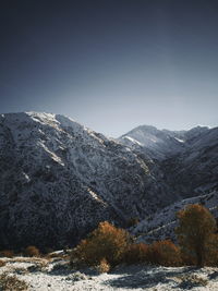 Scenic view of snowcapped mountains against clear sky