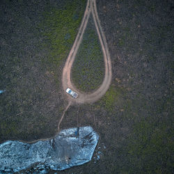 High angle view of road sign on field