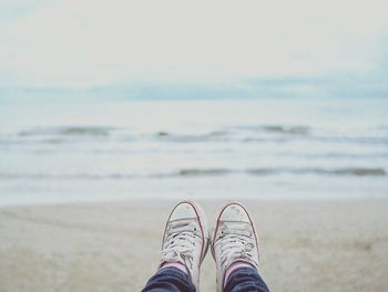 Low section of man resting at beach