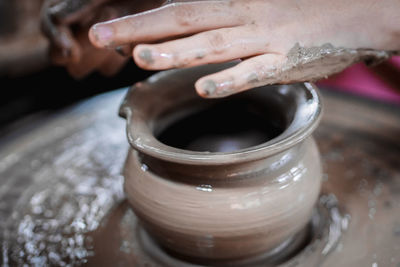 Close-up of artist making pot at workshop