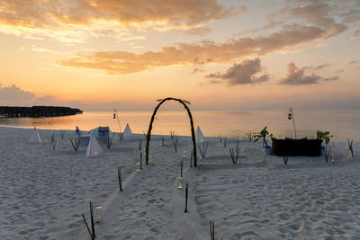 Scenic view of beach against sky during sunset