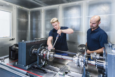 Two colleagues working in modern factory