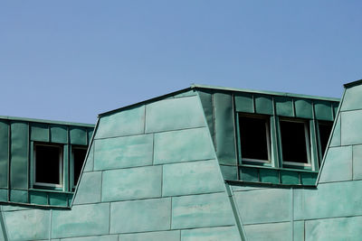 Low angle view of building against clear blue sky