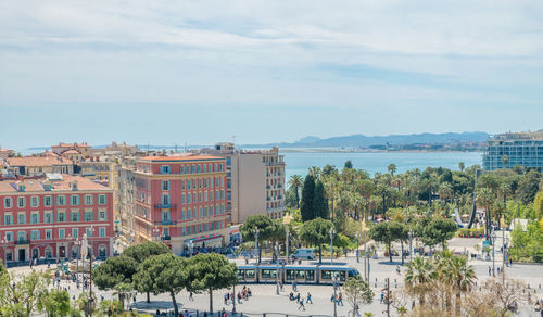 Buildings by sea against sky in city