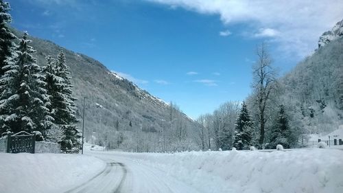 Scenic view of snow covered mountains against sky