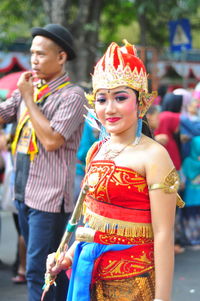 Portrait of woman standing in traditional clothing on street