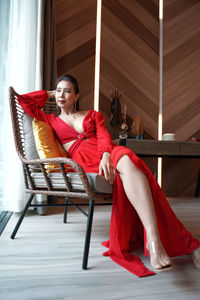 Woman sitting on chair at home