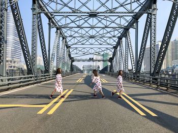 People running on road bridge