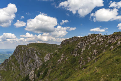 Scenic view of mountains against cloudy sky