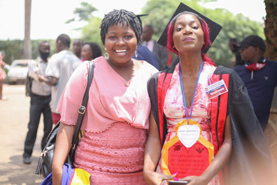 Portrait of smiling young women standing outdoors