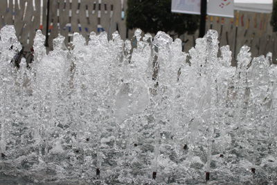 Frozen fountain in city during winter