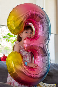 Portrait of cute girl with balloons