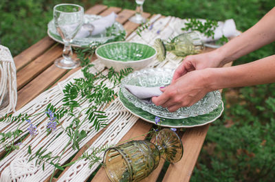 Cropped hand of person preparing food on table