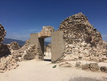 Ruins of building against blue sky