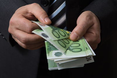 Close-up of hand holding paper