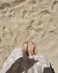 Low section of woman standing on beach