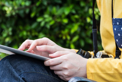 Midsection of man using mobile phone