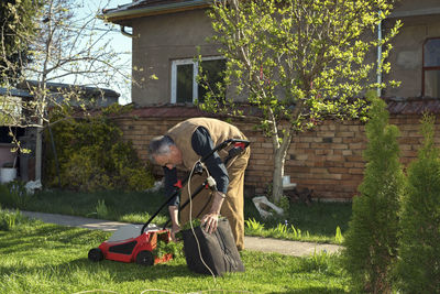 Man mowing at yard