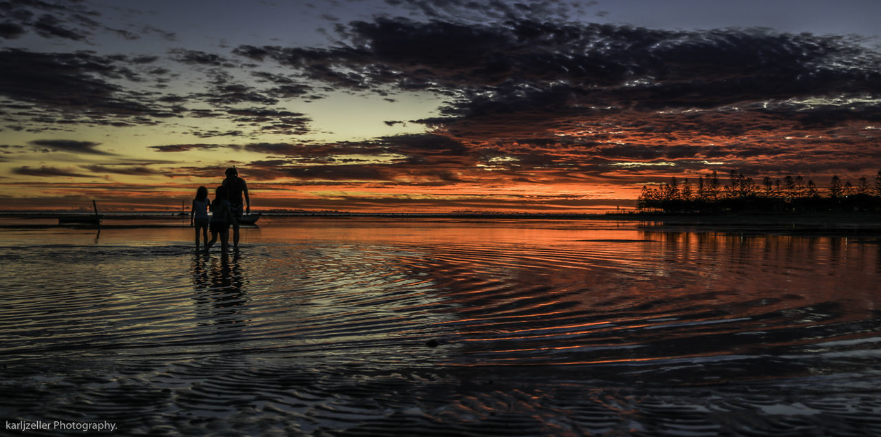 SILHOUETTE MAN STANDING IN SEA AGAINST SKY